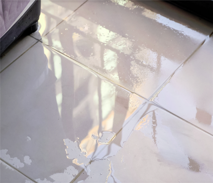 water covering the tile floor in a house