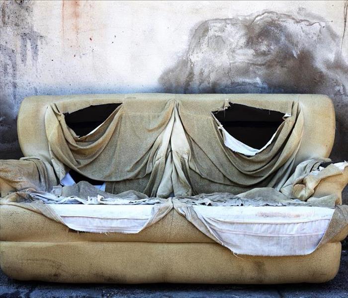 sofa with smoke and soot, ripped cover